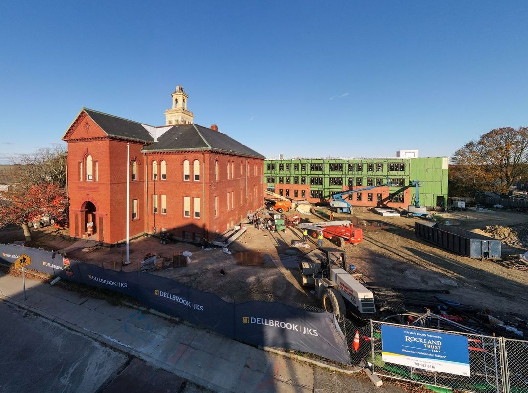 This late-day November light is casting interesting shadows over our progress at Oxford School Residences! ud83cudfeb Behind this lovely old schoolhouse in #Fairhaven, our teams are beginning the brick fau00e7ade that will make this new 39-residential-unit building look right at home next to its historic neighbor.